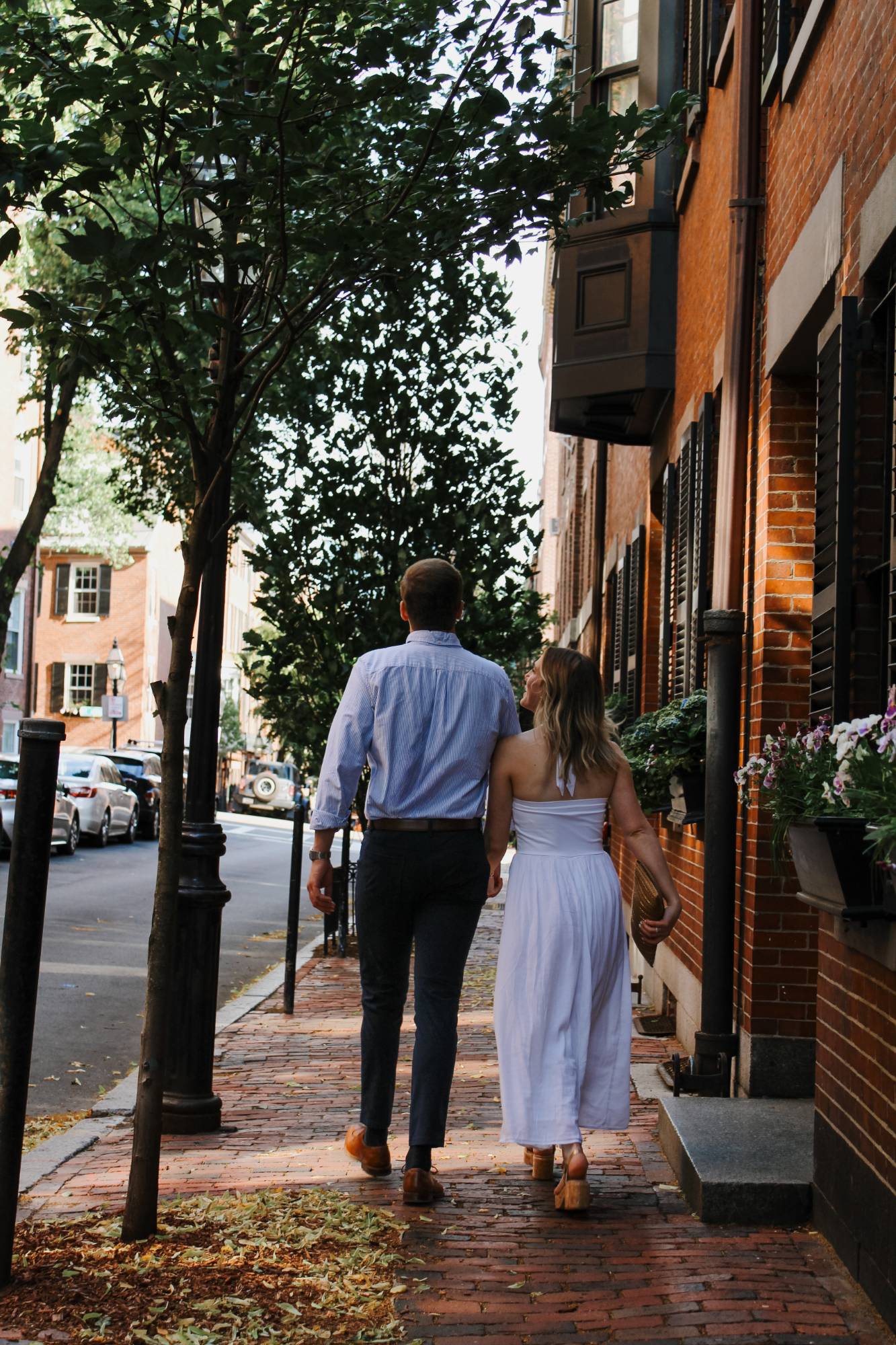 Engagement session on a tree-lined brick sidewalk in Beacon Hill, Boston