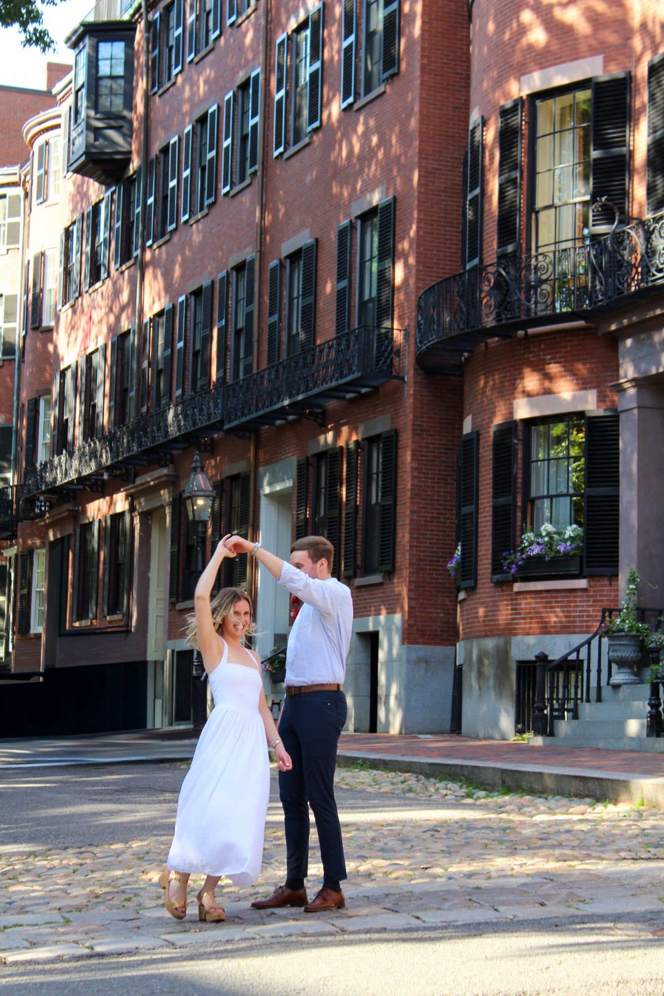 Couple dancing on a cobblestone street in Beacon Hill, Boston