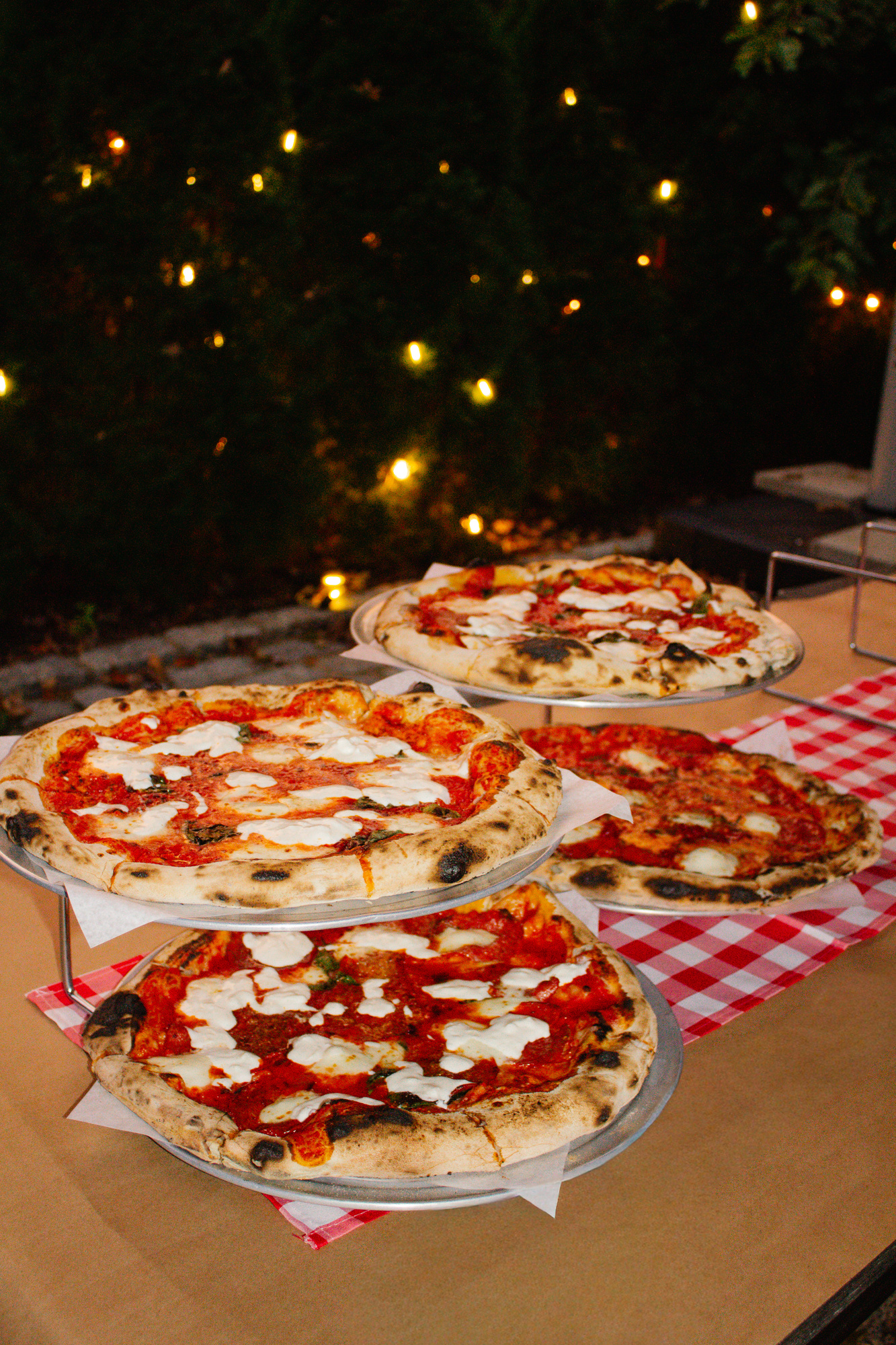 Wood-fired margherita pizzas on tiered stands at a welcome dinner at Otto Pizza in Chester, Connecticut