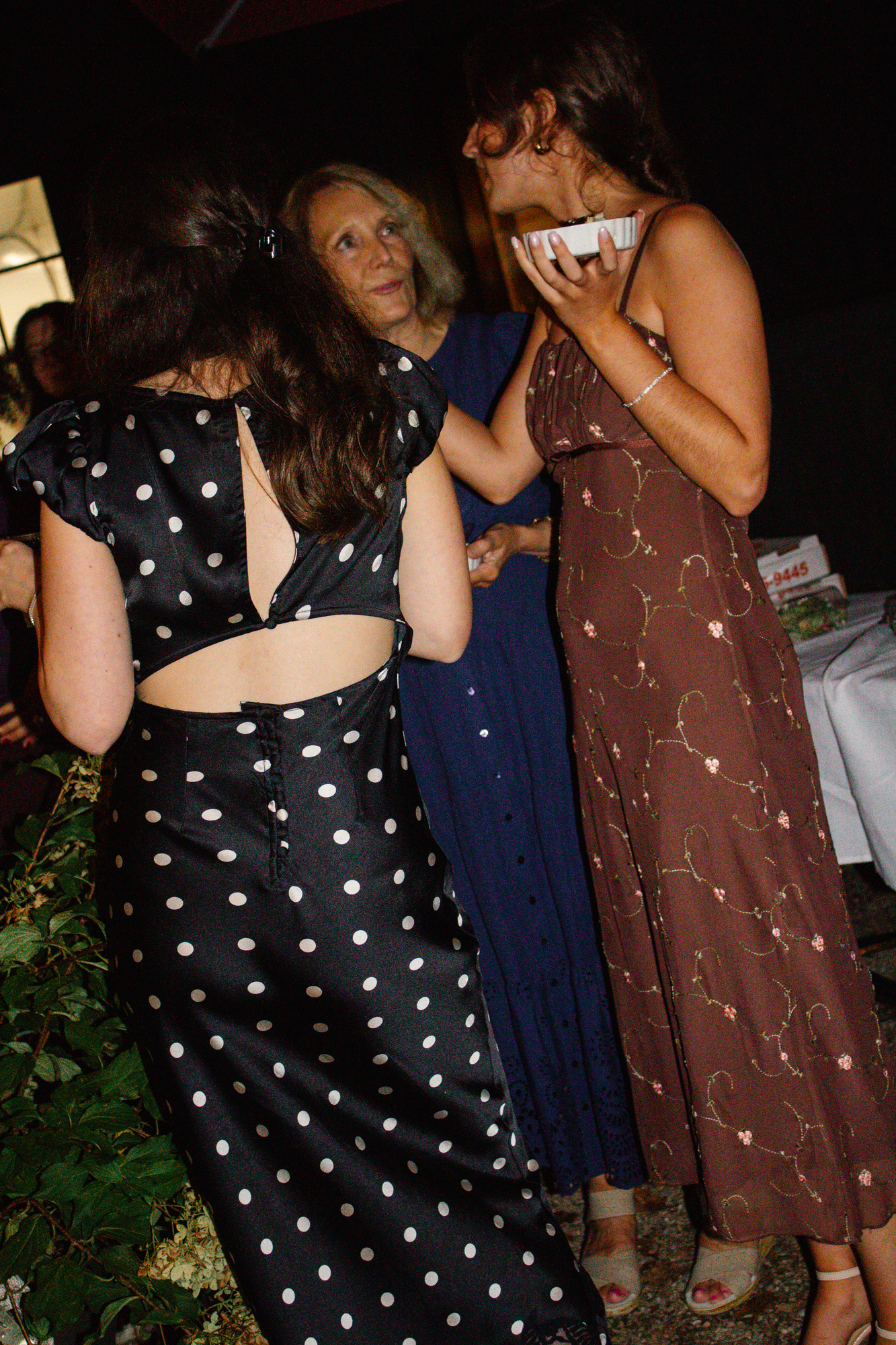 Guests laughing together beside the garden during a welcome dinner at Otto Pizza in Chester, Connecticut