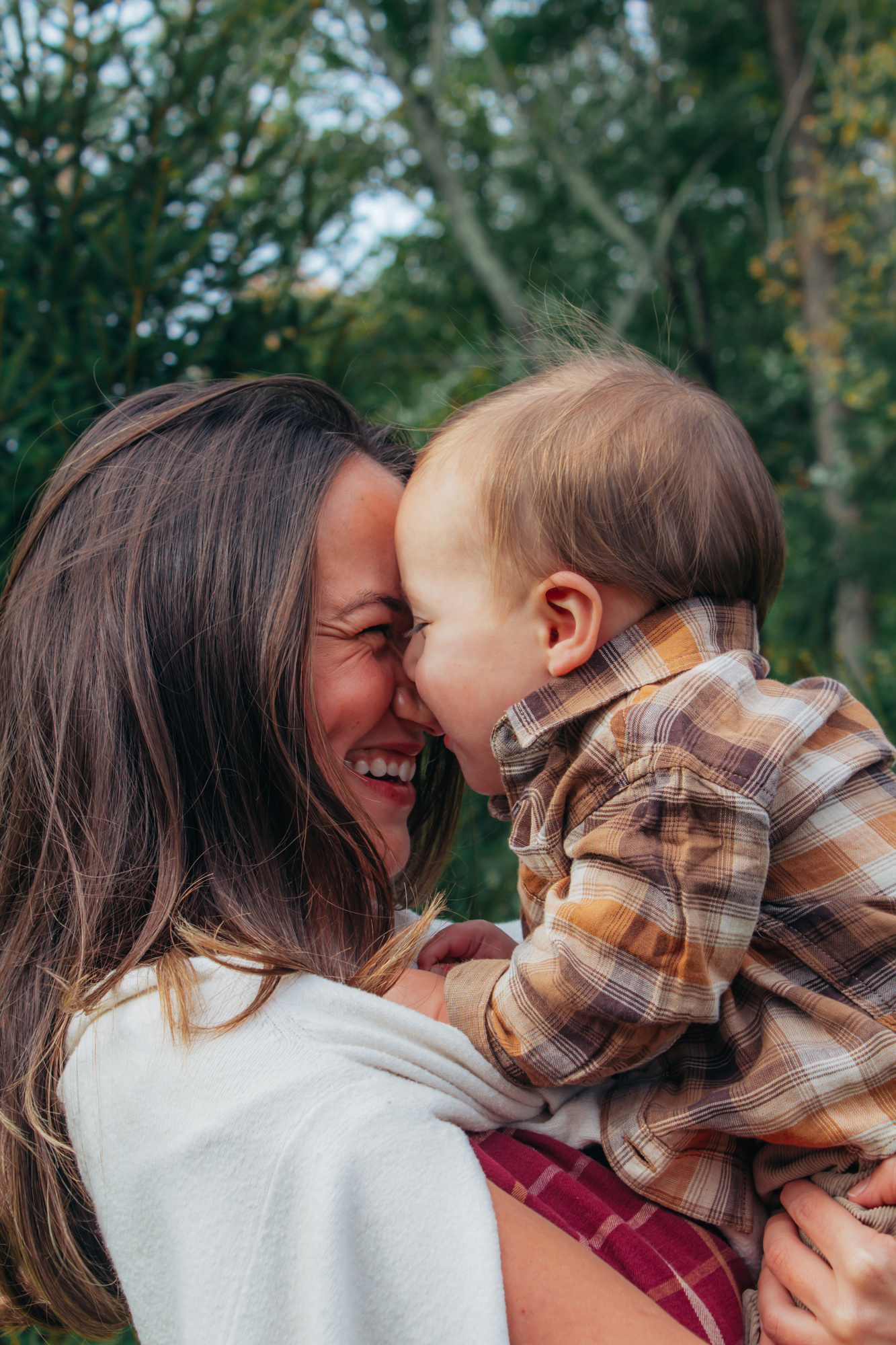 Mother and son touching noses and smiling during a fall family session in Easton, Connecticut